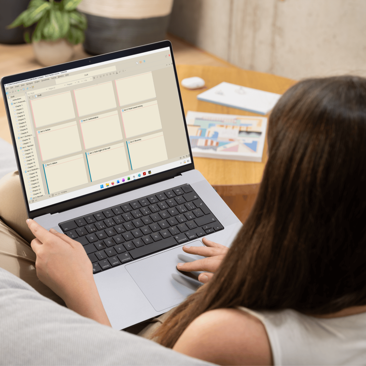 Person using a laptop on a couch. The screen shows part of the Chaos to Clarity bundle. 